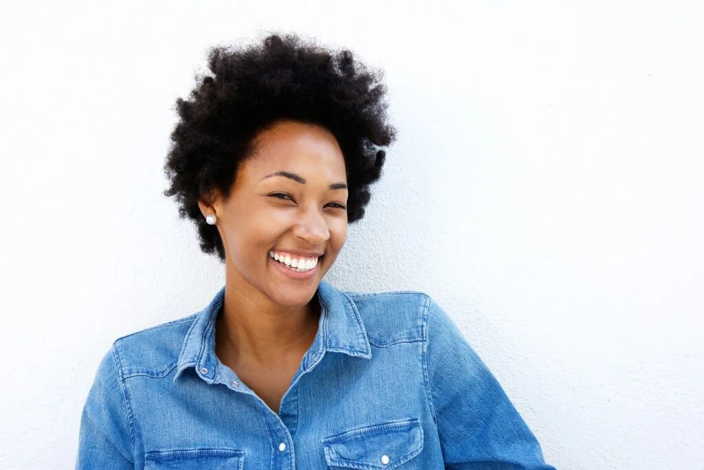 Cheerful woman smiling against white background